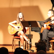 Jasmine Clarke, young girl playing guitar and singing at 88 Keys Academy Arcadia spring recital
