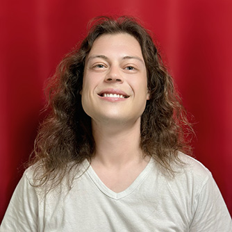 Image of Nick Ginsburg, a teacher at 88 Keys Music Academy, with a red background.